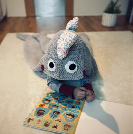 Cozy dinosaur blanket with hood – handmade crochet blanket for children.